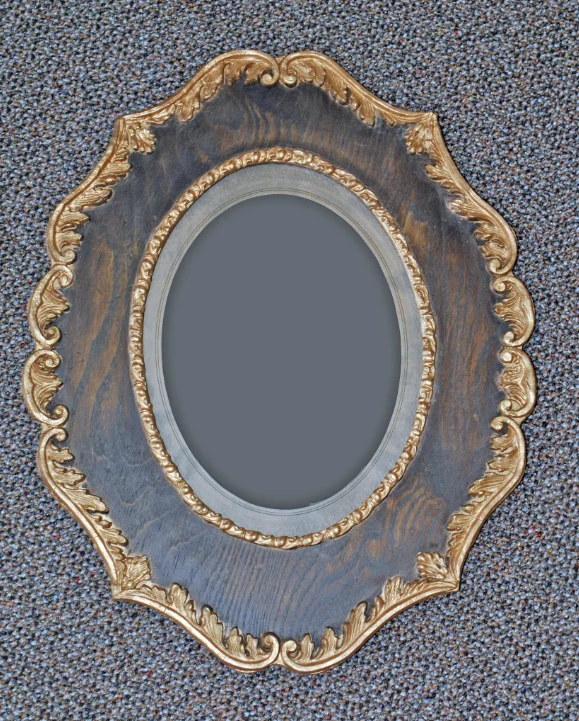 Ornate gilt oval frame with carved leaf ornament
